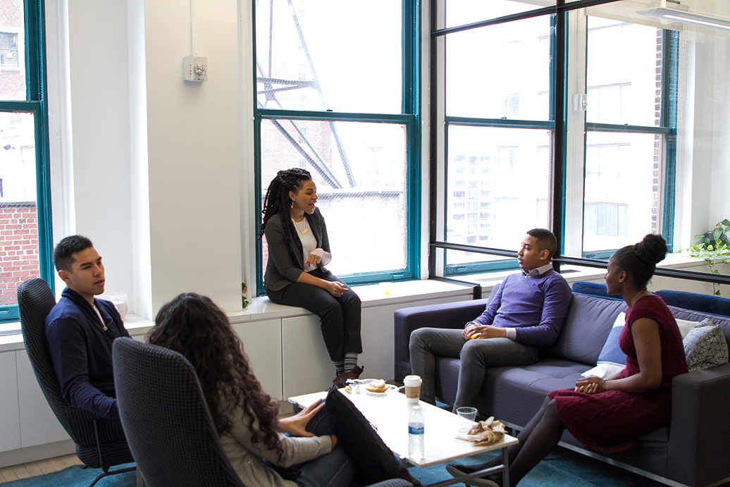 Image of 5 people seated in a meeting