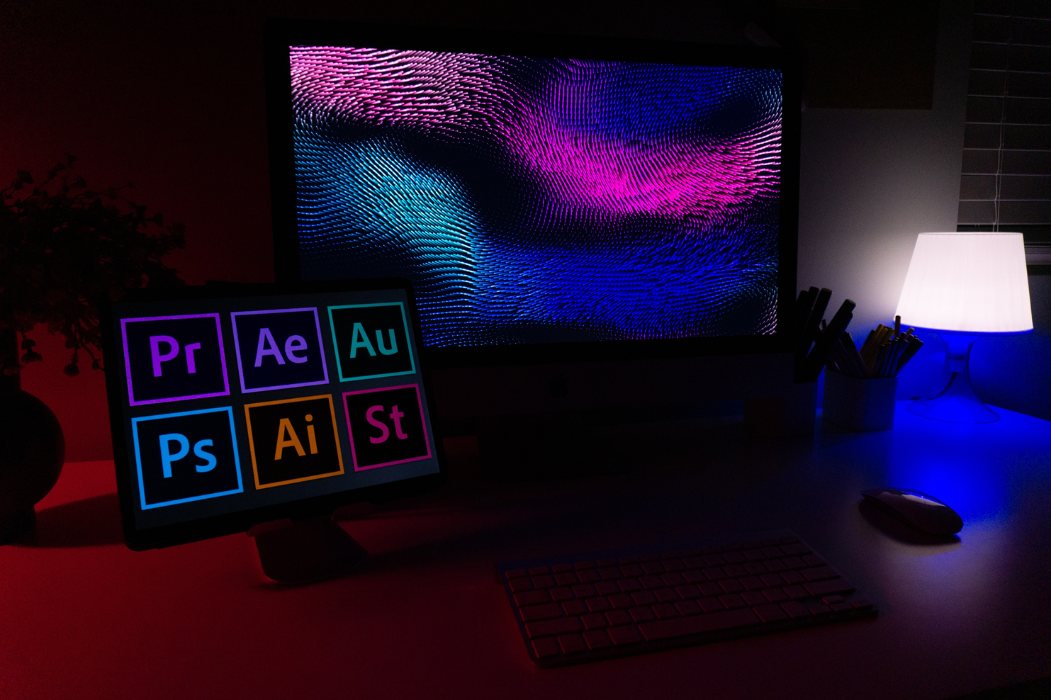 Image of a small desktop monitor with large icons for six design applications and a large monitor with an abstract design